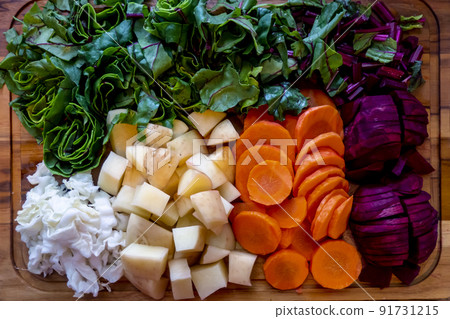 Board with ingredients for preparing tasty borscht on white background Board with ingredients for preparing tasty borscht on white background 91731215