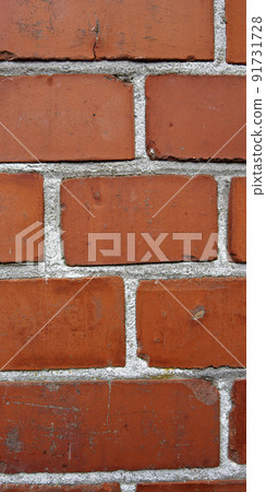 A close up still life of a wall of red bricks. Hard solid building material with a rough texture on a building in town, city, or house. Concrete surface with cement lining to keep a structure intact 91731728