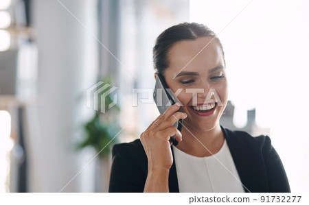 Shes got success on the line. Cropped shot of an attractive young businesswoman answering a phone call inside her office. Shes got success on the line. Cropped shot of an attractive young businesswoman answering a phone call inside her office. 91732277