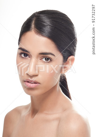 Shes serious about beauty care. Studio portrait of a beautiful young woman isolated on white gazing seriously at the camera. Shes serious about beauty care. Studio portrait of a beautiful young woman isolated on white gazing seriously at the camera. 91732297