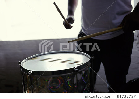 Beats of Brazil. Cropped shot of a man beating his drum. 91732757