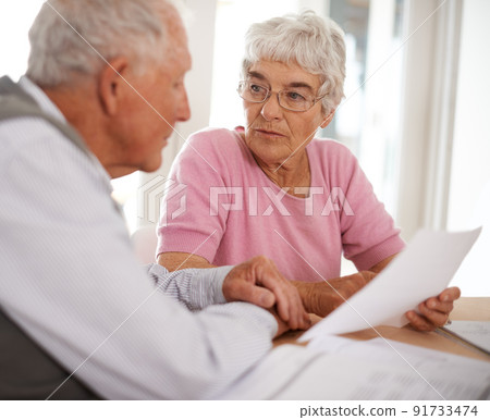 Taking time to discuss important matters. Shot of two elderly people discussing a document. Taking time to discuss important matters. Shot of two elderly people discussing a document. 91733474