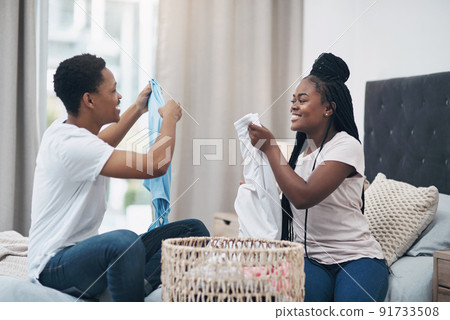 Marriage is the best partnership youll ever sign up for. Shot of a young couple doing laundry together at home. 91733508