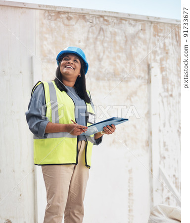 Making sure everything is up to code. Cropped shot of an attractive young female construction worker working on site. 91733677