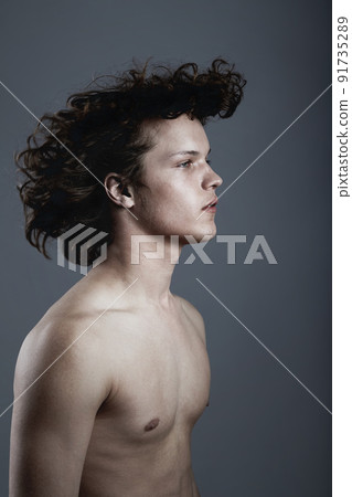 Easy fashion. Studio shot of a handsome young man posing against a gray background. 91735289