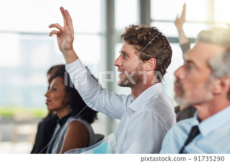 Its the question and answer portion. Cropped shot of a handsome young businessman raising his hand during a seminar. 91735290