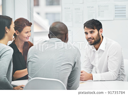 Hes bringing fresh ideas to the table. Shot of coworkers having a meeting at the office. 91735784