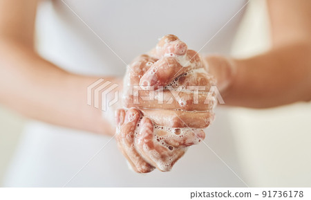 Keep clean and safe from germs. Closeup shot of a woman washing her hands with soap. 91736178