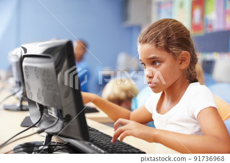 Wow, computer class is really interesting. A cute schoolgirl in computer class. 91736968