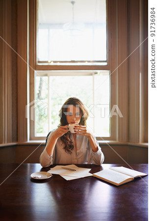 Some coffee...and Im ready to write again. Portrait of an attractive young author enjoying a cup of coffee while writing indoors. Some coffee...and Im ready to write again. Portrait of an attractive young author enjoying a cup of coffee while writing indoors. 91736984