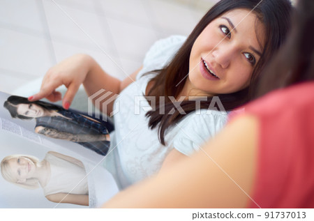 Time for something new. Shot of a woman showing some new hairstyle options and looking for advice. 91737013