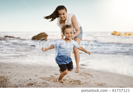 Its all fun and games at the beach. Shot of a mother bonding with her little son at the beach. 91737121