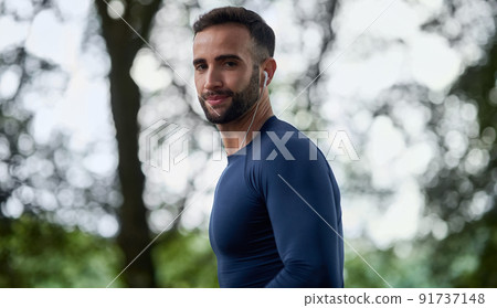 I wont stop until Im done. Cropped portrait of a handsome young male runner listening to music during his workout. I wont stop until Im done. Cropped portrait of a handsome young male runner listening to music during his workout. 91737148