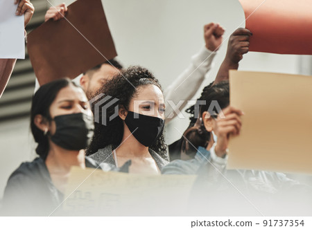 Its time to get involved. Low angle shot of a group of people holding signs while taking part in a political rally. 91737354