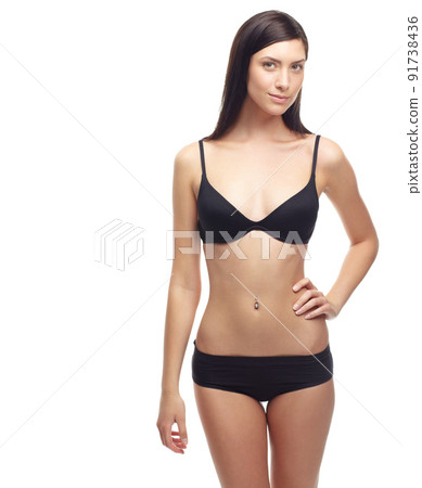 Shes got a body to die for. A slim young woman in her underwear isolated on a white background. 91738436