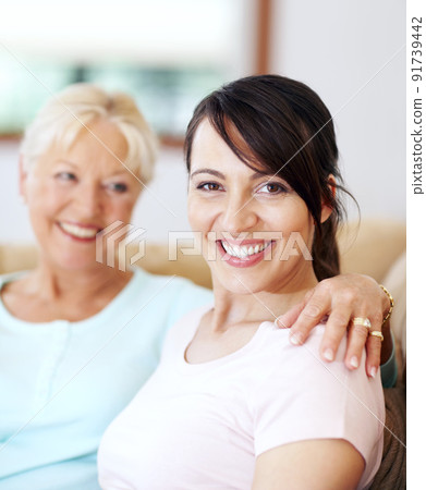 Mother and daughter bonding time is special. Portrait of a beautiful smiling woman sitting with her mother. Mother and daughter bonding time is special. Portrait of a beautiful smiling woman sitting with her mother. 91739442
