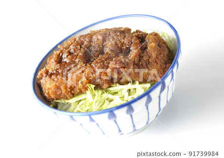 A hot sauce and a bowl with a cutlet entwined with plenty of sauce on top of shredded cabbage taken on a white background 91739984