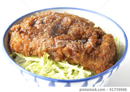 A hot sauce and a bowl with a cutlet entwined with plenty of sauce on top of shredded cabbage taken on a white background A hot sauce and a bowl with a cutlet entwined with plenty of sauce on top of shredded cabbage taken on a white background 91739986