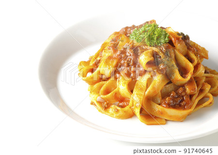 A hot bolognese with flat pasta fitcine and tomato sauce often entwined on a white background A hot bolognese with flat pasta fitcine and tomato sauce often entwined on a white background 91740645