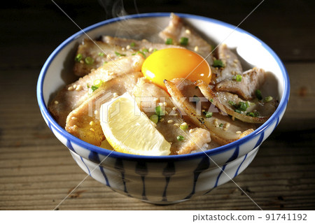 Hot pork bowl with cut lemon and egg yolk, grilled meat bowl Hot pork bowl with cut lemon and egg yolk, grilled meat bowl 91741192