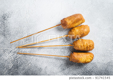 Homemade deep fried corn dogs. White background. Top view Homemade deep fried corn dogs. White background. Top view 91741545