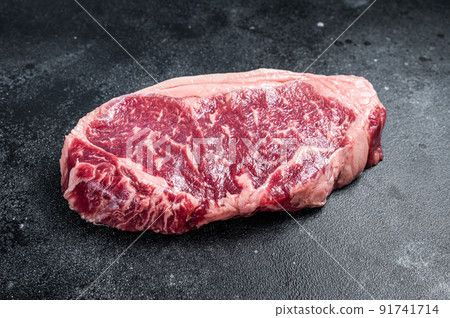 Raw Striploin steak, beef butchery cut. Black background. Top view 91741714
