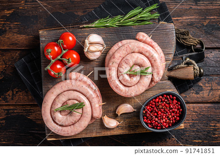 Bavarian Raw spiral sausages on a wooden board. Wooden background. Top view Bavarian Raw spiral sausages on a wooden board. Wooden background. Top view 91741851