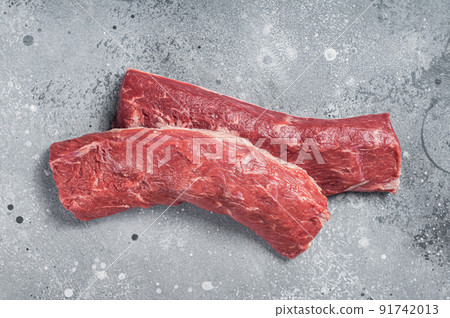 Raw lamb tenderloin Fillet, Mutton Sirloin Meat on butcher table. Gray background. Top view 91742013