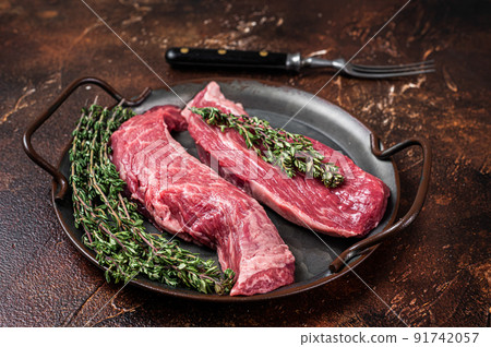 Raw Bavette or Sirloin flap beef meat steak with thyme. Dark background. Top view 91742057