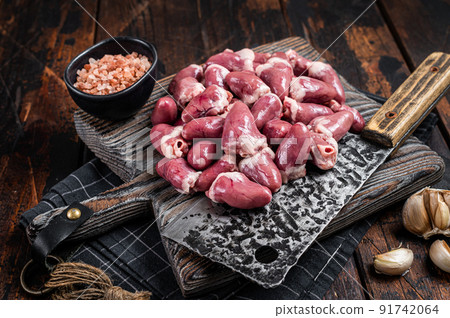 Butcher board with raw chicken hearts. Wooden background. Top view Butcher board with raw chicken hearts. Wooden background. Top view 91742064