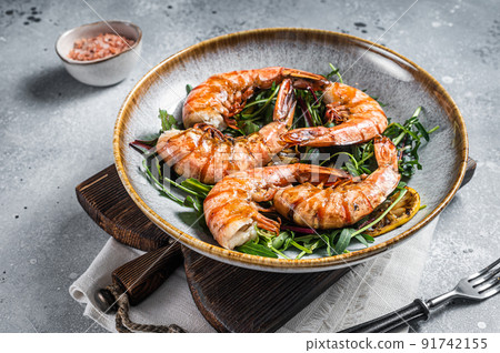 Salad with grilled Giant shrimps prawns in plate. Gray background. Top view 91742155