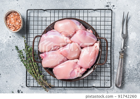 Boneless and skinless Raw Chicken leg thigh fillet. Gray background. Top view Boneless and skinless Raw Chicken leg thigh fillet. Gray background. Top view 91742260