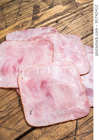 Square Slices of pork ham on wooden table. Wooden background. Top view 91742412