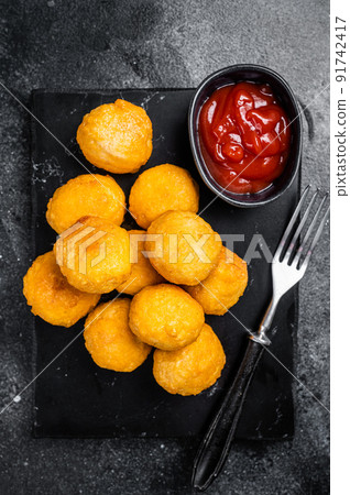 Creamy Mashed Potato Croquettes with Cheese served on a marble board. Black background. Top view Creamy Mashed Potato Croquettes with Cheese served on a marble board. Black background. Top view 91742417