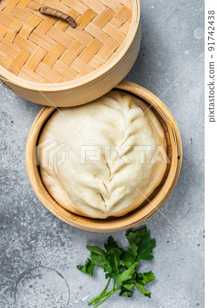 Pyanse steamed bun in a Bamboo steamer, korean street food. Gray background. Top view 91742438