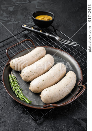 Traditional German Bavarian white sausage in steel tray with mustard. Black background. Top view 91742458