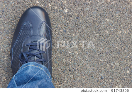Navy blue leather shoes on asphalt road or footpath. Male footwear. Copy space for text 91743806