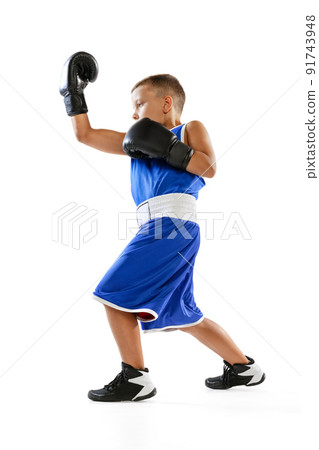 Sportive little boy, kid in boxer gloves and shorts training isolated on white studio background. Concept of sport, movement, studying, achievements, lifestyle. Sportive little boy, kid in boxer gloves and shorts training isolated on white studio background. Concept of sport, movement, studying, achievements, lifestyle. 91743948