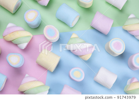 multicolored chewy marshmallows on a multicolored background, the concept of a birthday, holiday, fun, trendy sweet background.  91743979