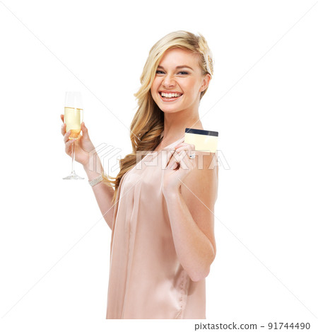 Charge it to the card. Portrait of a gorgeous young blonde woman holding up her credit card in one hand and a glass of champagne in the other. Charge it to the card. Portrait of a gorgeous young blonde woman holding up her credit card in one hand and a glass of champagne in the other. 91744490