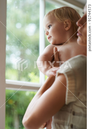 Whats out there. A baby boy and his mother looking out the window. Whats out there. A baby boy and his mother looking out the window. 91744573