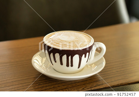 Cappuccino coffee in ceramic cup on wooden table Cappuccino coffee in ceramic cup on wooden table 91752457