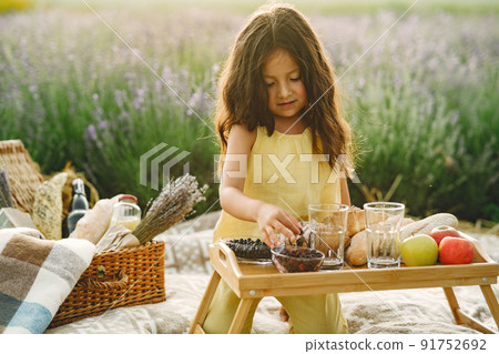 Provence child relaxing in lavender field. Little girl in a picnic. 91752692