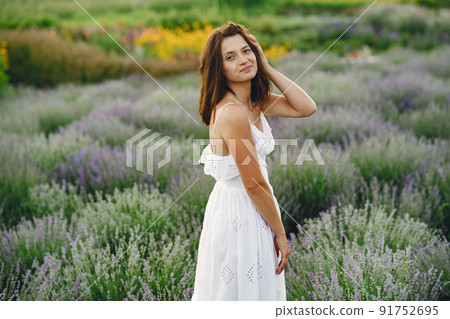 Provence woman relaxing in lavender field. Lady in a white dress. Girl with bag. 91752695