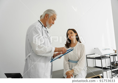 Therapist conducts a preventive examination of a woman in her office in a modern clinic Therapist conducts a preventive examination of a woman in her office in a modern clinic 91753633