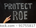A woman's hand points to the abortion inscription and the law against abortion 91755817