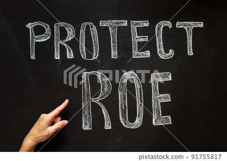 A woman's hand points to the abortion inscription and the law against abortion 91755817