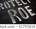 A sign that says Protect ROE. Demonstrators' poster. Women and their rights. 91755818