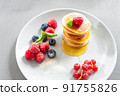Food for breakfast healthy eating. Pancakes with honey. Homemade pancakes on a white background. European breakfast pancakes and berries. Pancakes without butter with berries. Food for vegetarians and 91755826