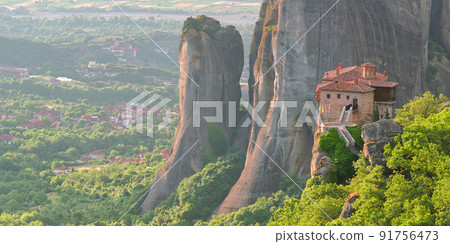 Stone monastery in the mountains. Kalabaka, Greece summer cloudy day in Meteora mountain valley. 91756473